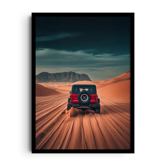 Framed poster of a sleek car silhouette among desert dunes under a warm amber sunset, road trip wall art