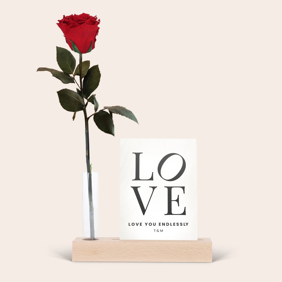 Infinity rose in glass tube beside a custom printed photo stand