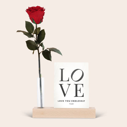 Infinity rose in glass tube beside a custom printed photo stand