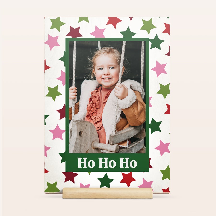 Plywood Christmas card on wooden stand, close-up detail, customized with a festive photo and text