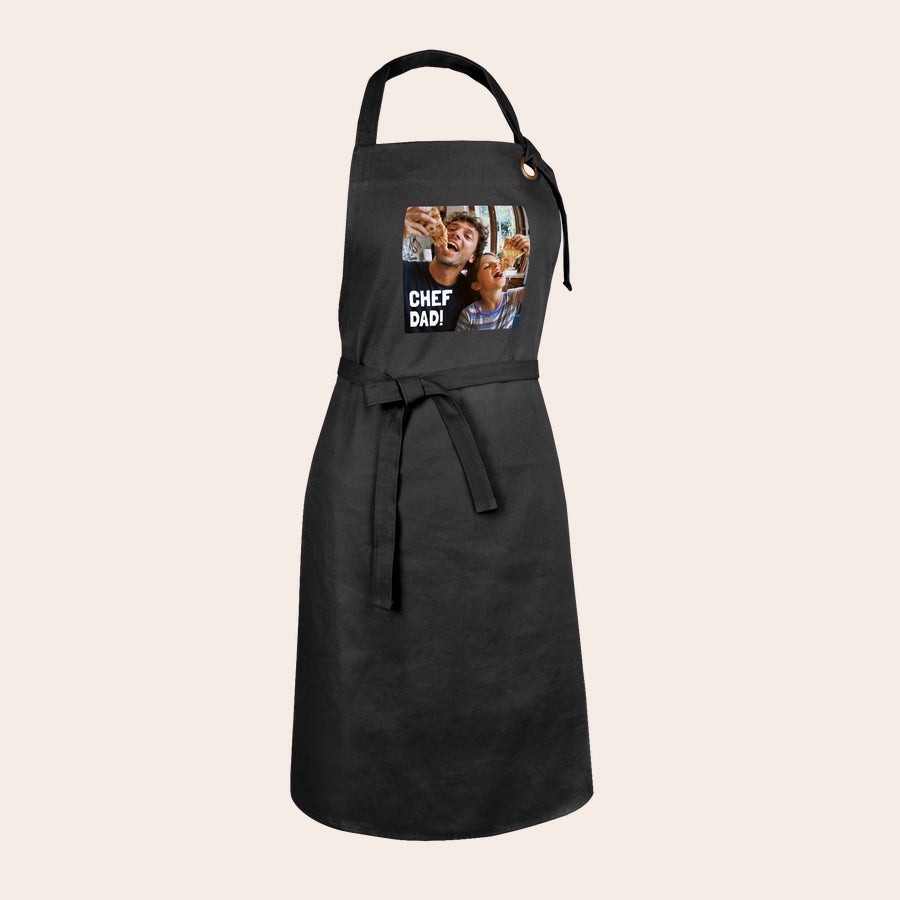 Personalized apron shown worn in the kitchen, example personalization